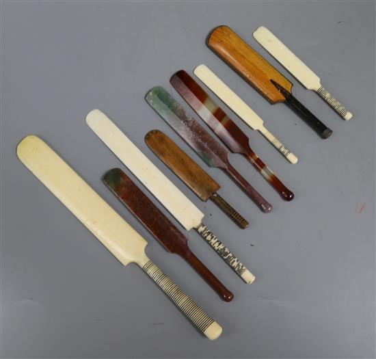 Nine assorted miniature cricket bats, including two ivory letter openers, three agate, two wooden and two small ivory.